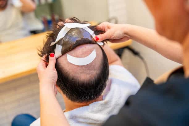 Man with a short, side-parted hair system